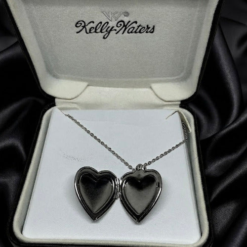 Heart-shaped locket necklace in a Kelly Waters box on black satin fabric