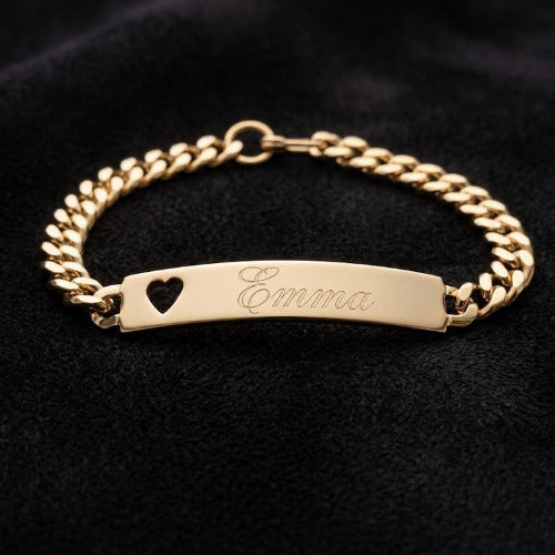 Gold Speidel bracelet with nameplate and heart cutout on black background
