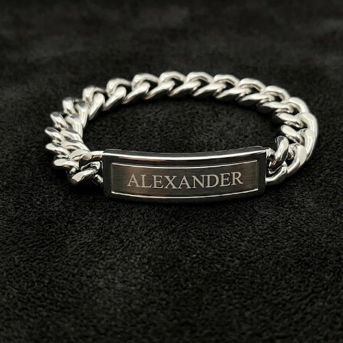 Silver chain bracelet with a nameplate on a black background