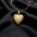 Heart-shaped gold locket with 'I love you' engraving on a black fabric background