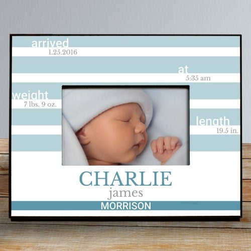 Framed photo of a newborn baby with personalized details on a striped background