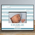 Framed photo of a newborn baby with personalized details on a striped background
