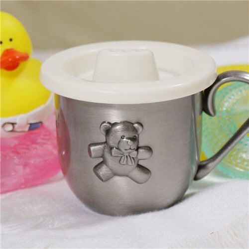 Metal cup with teddy bear design and white lid on a white surface