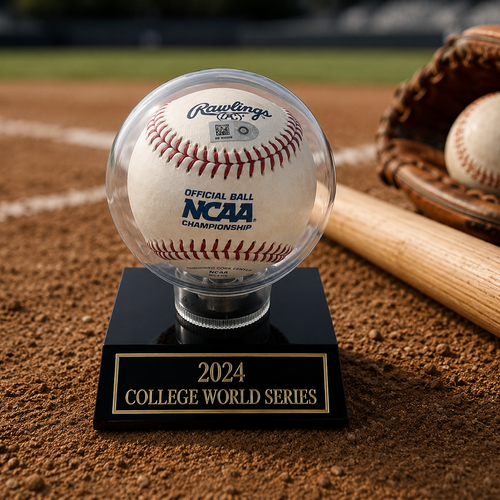 Baseball on a stand with 'NCAA' and '2024 College World Series' text, surrounded by a baseball glove and bat on a dirt field.