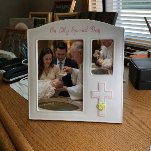 Picture frame with words On My Special Day imprinted in pink lettering and pink cross.
