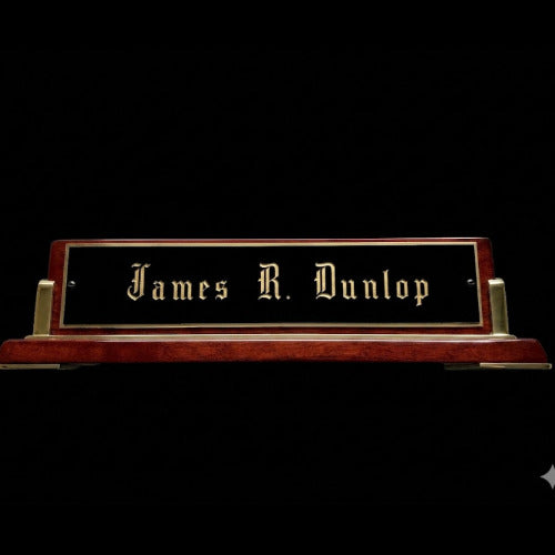 Wooden nameplate with 'James R. Dunlop' engraved on a black background