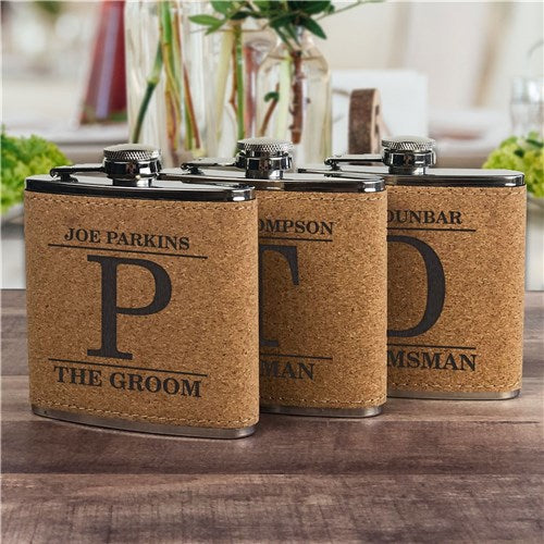 3 Cork flasks with different letters engraved.