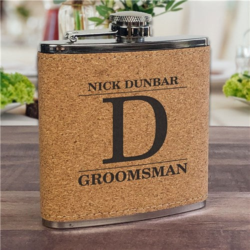 Cork flask with a letter D engraved setting on a table.
