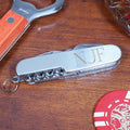 Multitool with 'NUF' engraving on a wooden surface