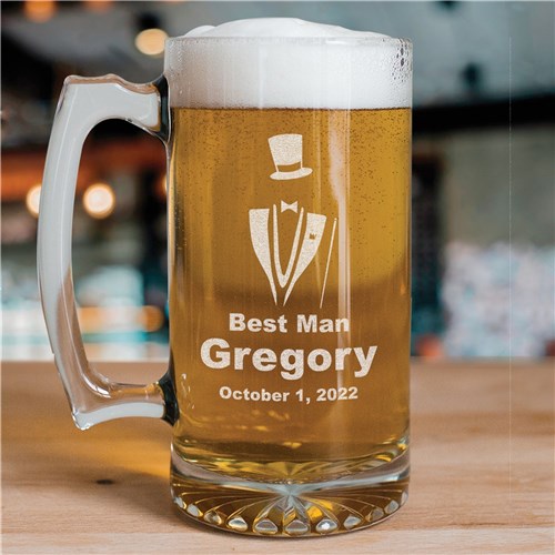 Personalized groomsman beer mug with engraved design and text on a wooden surface.