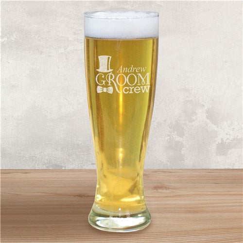 Groomsman beer glass with 'Andrew Groom Crew' engraving on a wooden surface and light gray background